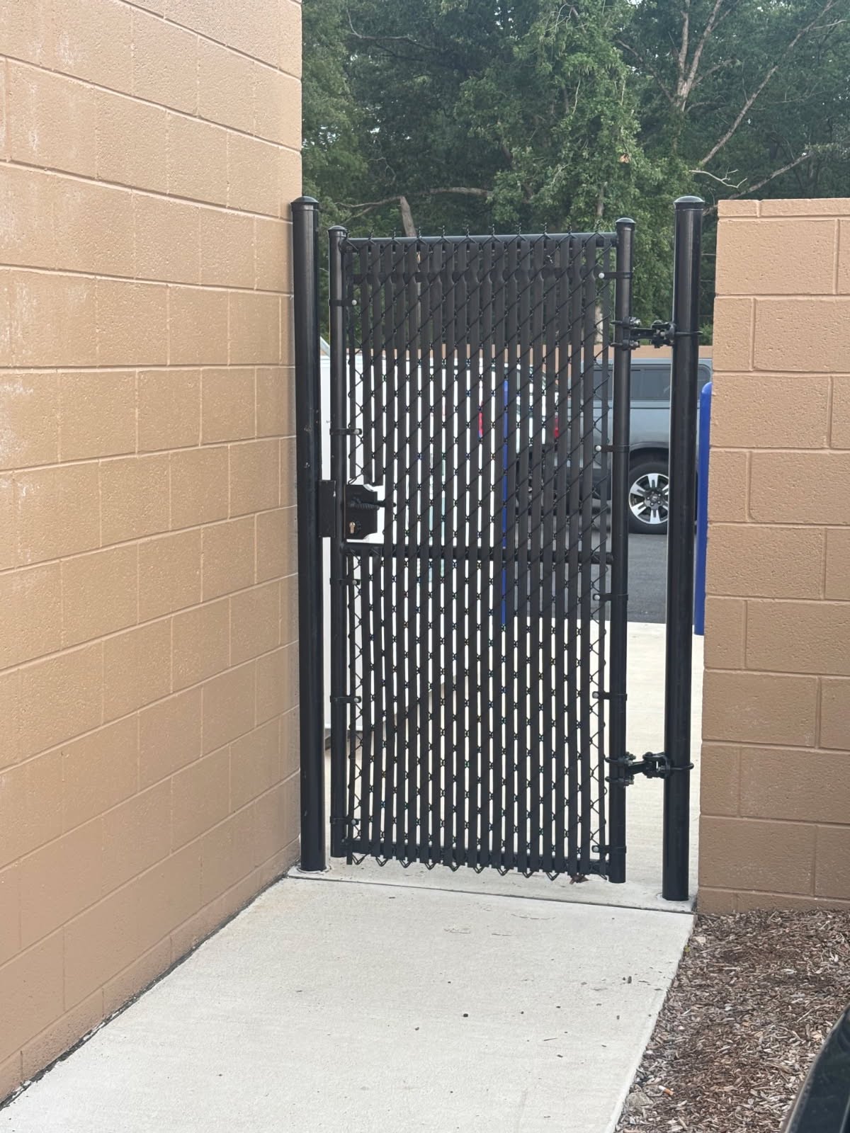 Chain-link pedestrian gate with privacy slats and hardware