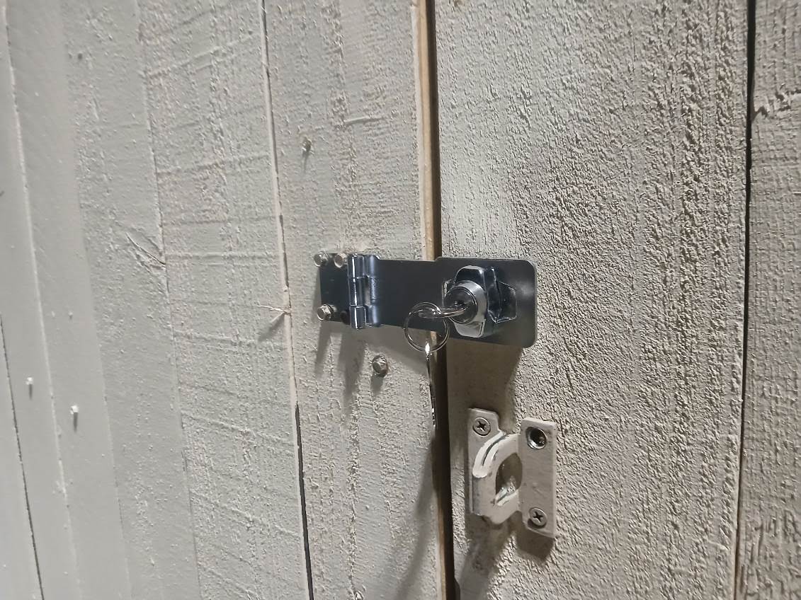 Keyed hasp installed on a wood door