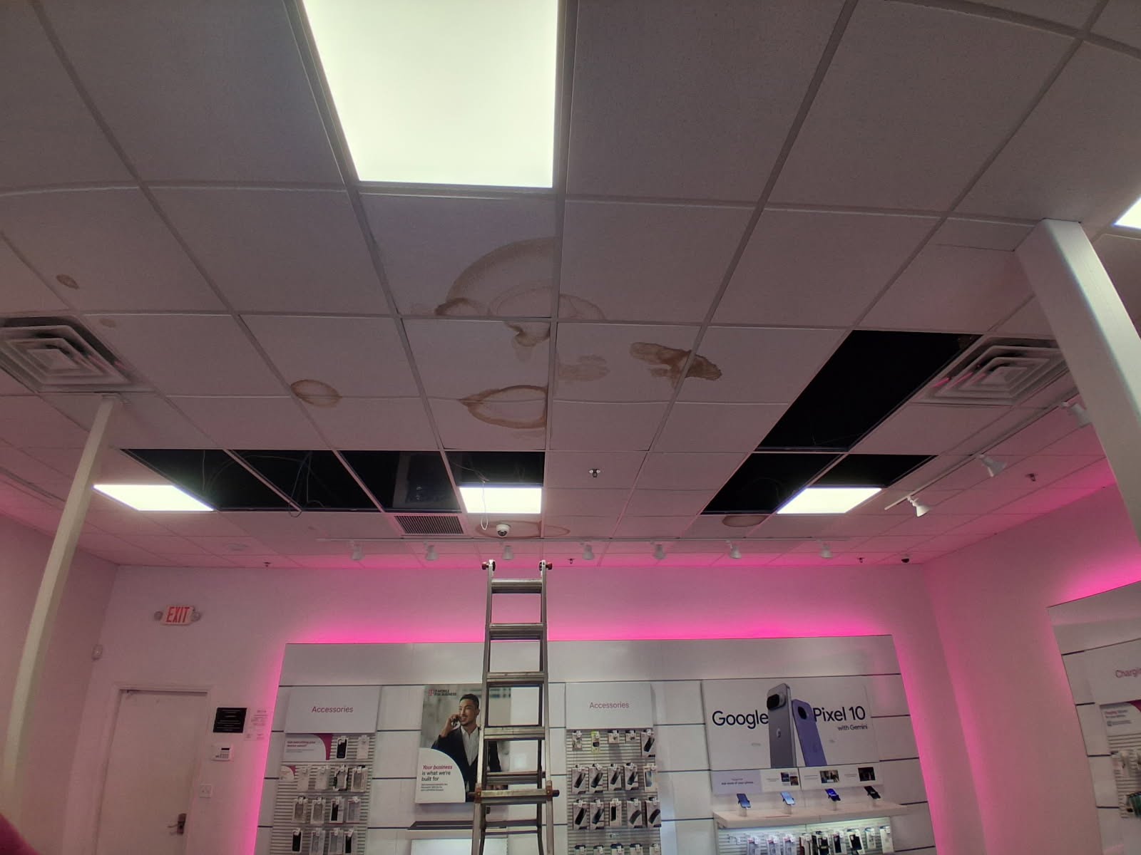 Commercial suspended ceiling with stained and missing tiles