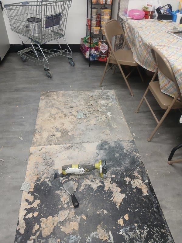 Floor covering removed to expose adhesive and substrate