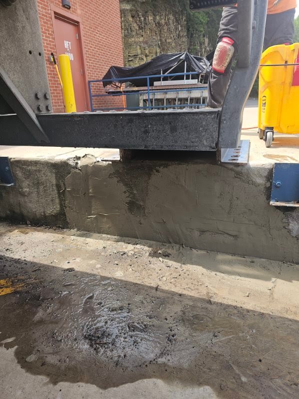 Fresh concrete patch at a commercial loading area