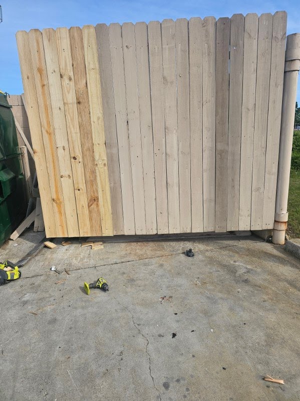 Wood fence section repaired with new boards