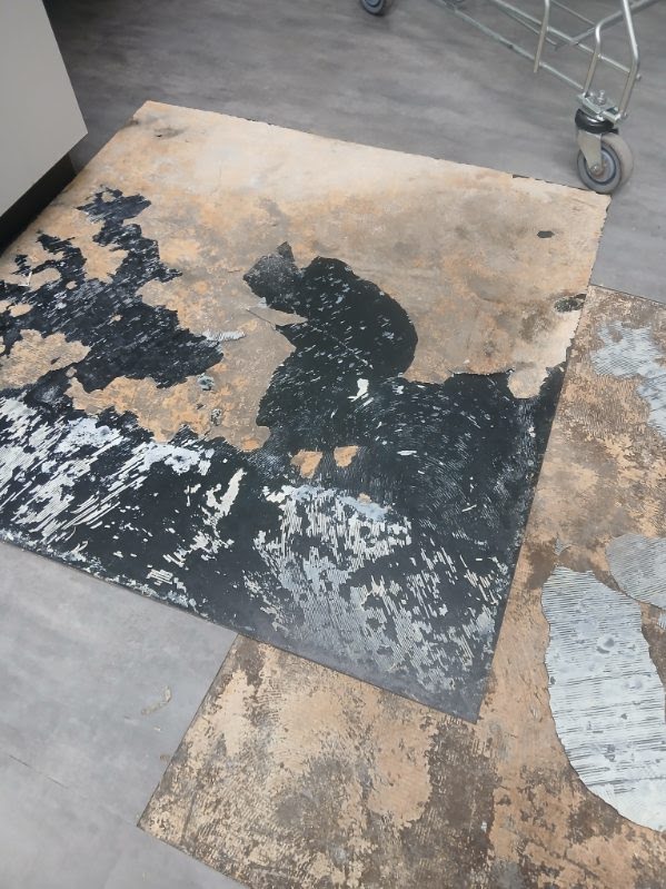 Removed floor finish with adhesive and substrate exposed