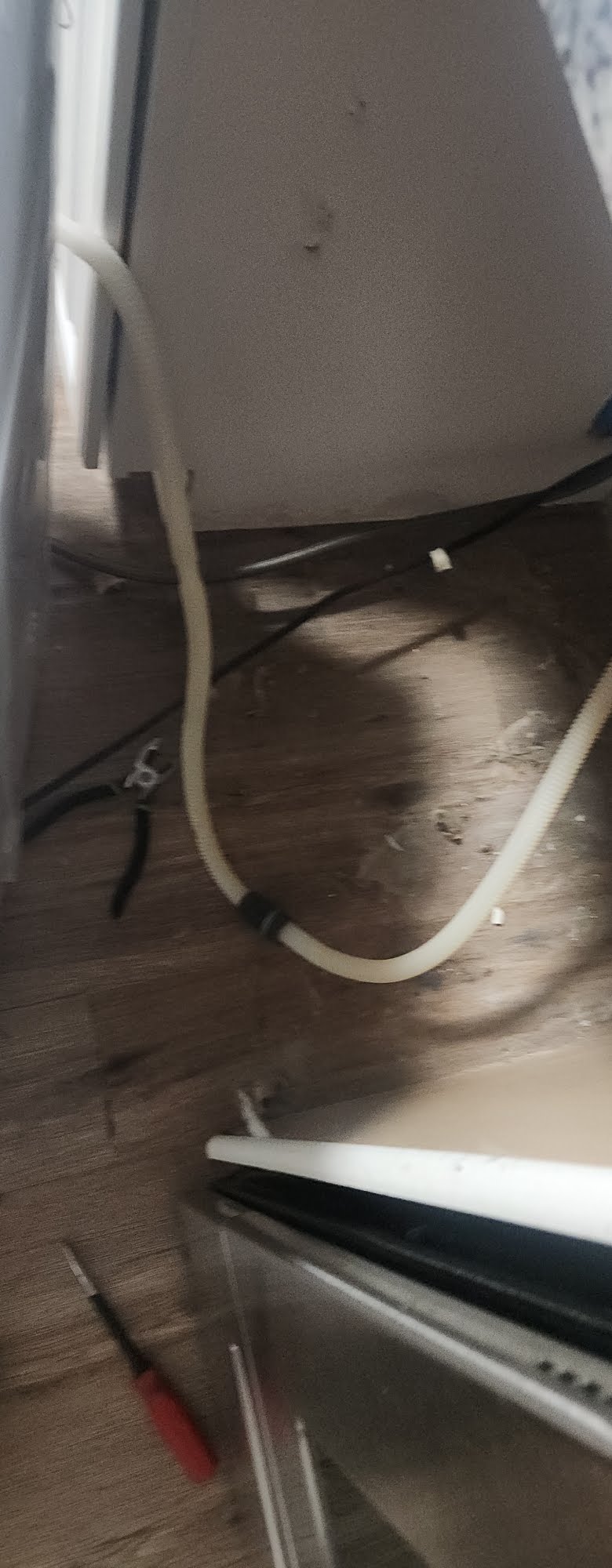 Drain and water connections behind an appliance