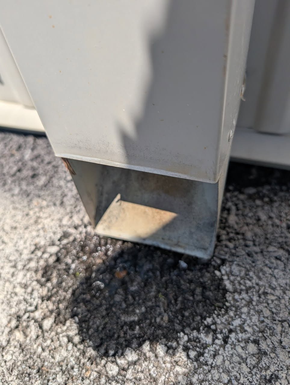 Close view of a downspout outlet at the adjacent ground surface