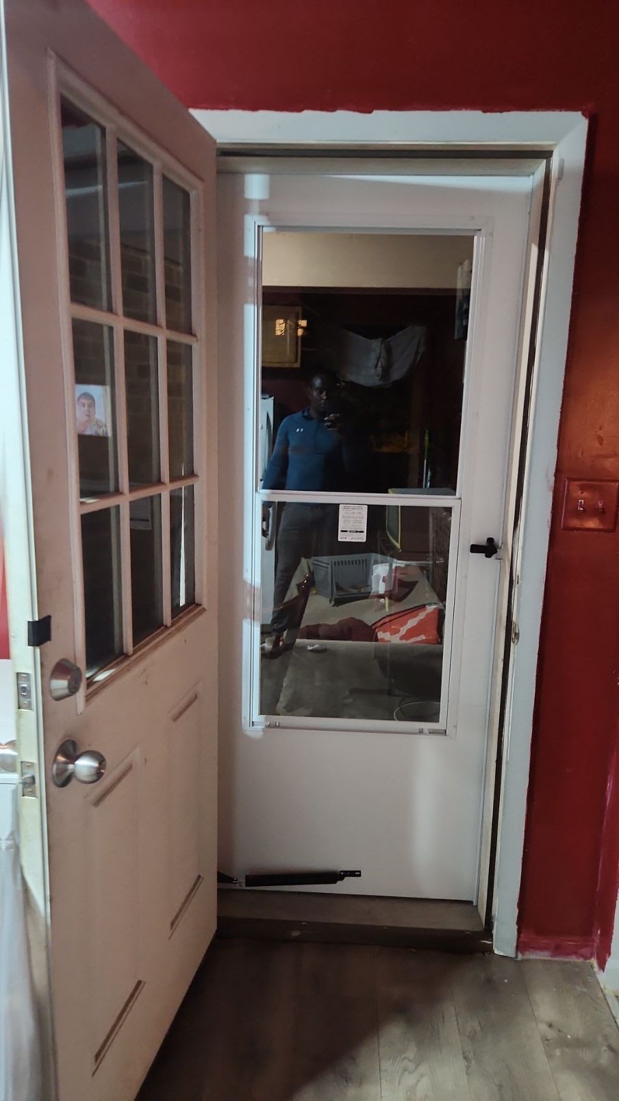 Interior view of an installed storm door and operating hardware