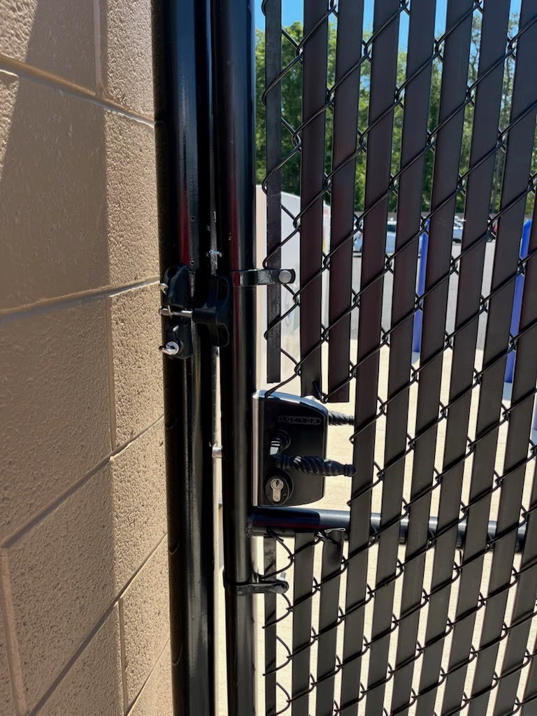 Keyed lock hardware installed on a chain-link gate